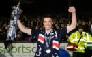 Dundee's Cammy Kerr with the Championship trophy. Image: SNS