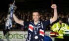 Dundee's Cammy Kerr with the Championship trophy. Image: SNS