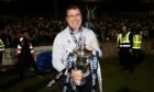 Former Dundee boss Gary Bowyer holds the Championship trophy.