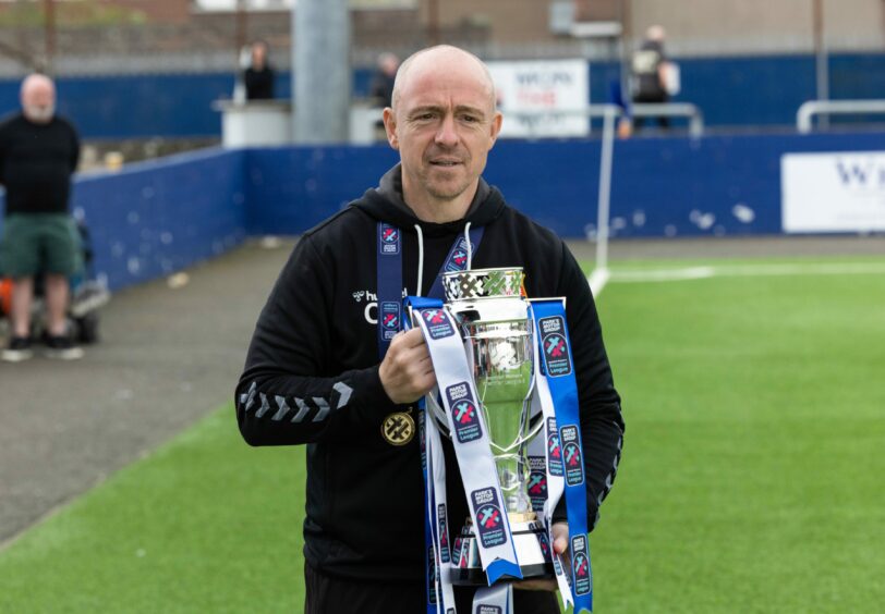 Montrose boss Craig Feroz with the SWPL2 title. Image: SNS.