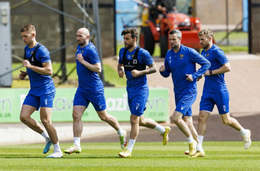 The St Johnstone squad warm-up during the pre-match training session. 