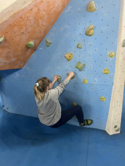 Rebecca Baird on a climbing wall