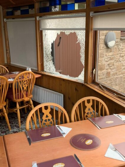 A smashed window at the Birkhill Inn restaurant