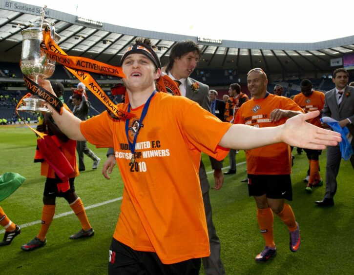 Conway on the Hampden pitch with the 2010 prize. Image: SNS.