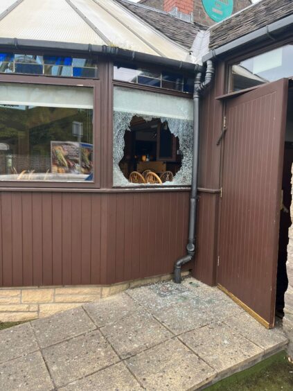 A smashed window at the Birkhill Inn.