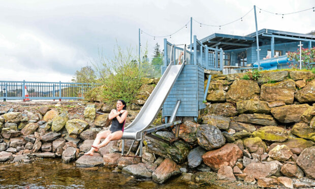 Gayle plunges into the icy waters of Loch Tay via Taymouth Marina's slide. Picture: Kenny Smith.