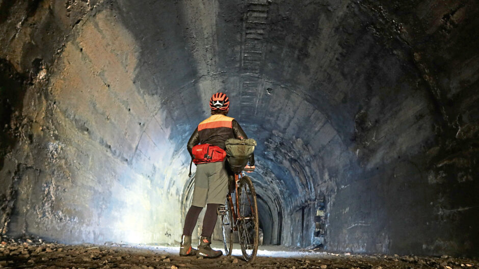 Markus exploring Glenfarg's tunnels by bike.
