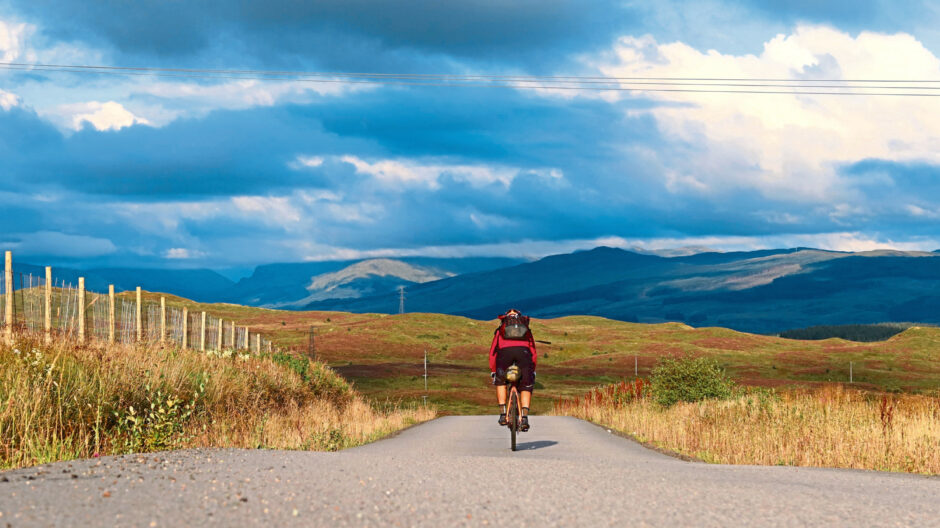 A cyclist amid some stunning Scottish scenery.
