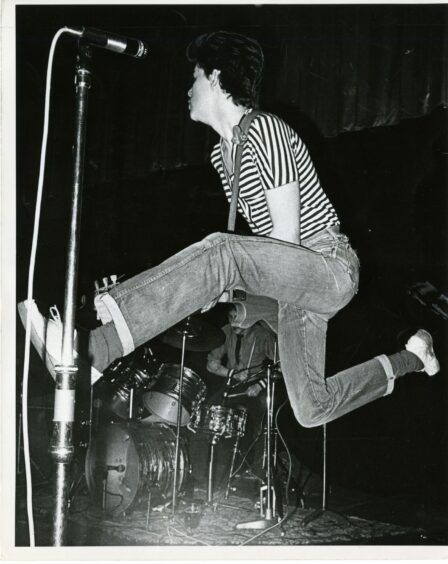 Adamson jumping while on stage