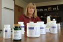 Lorraine Murray with the antibiotics and medication she has been taking to combat Lyme disease and the other infections she contracted from an infected tick. Image: Mhairi Edwards/DC Thomson.