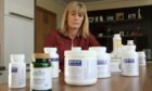 Lorraine Murray with the antibiotics and medication she has been taking to combat Lyme disease and the other infections she contracted from an infected tick. Image: Mhairi Edwards/DC Thomson.
