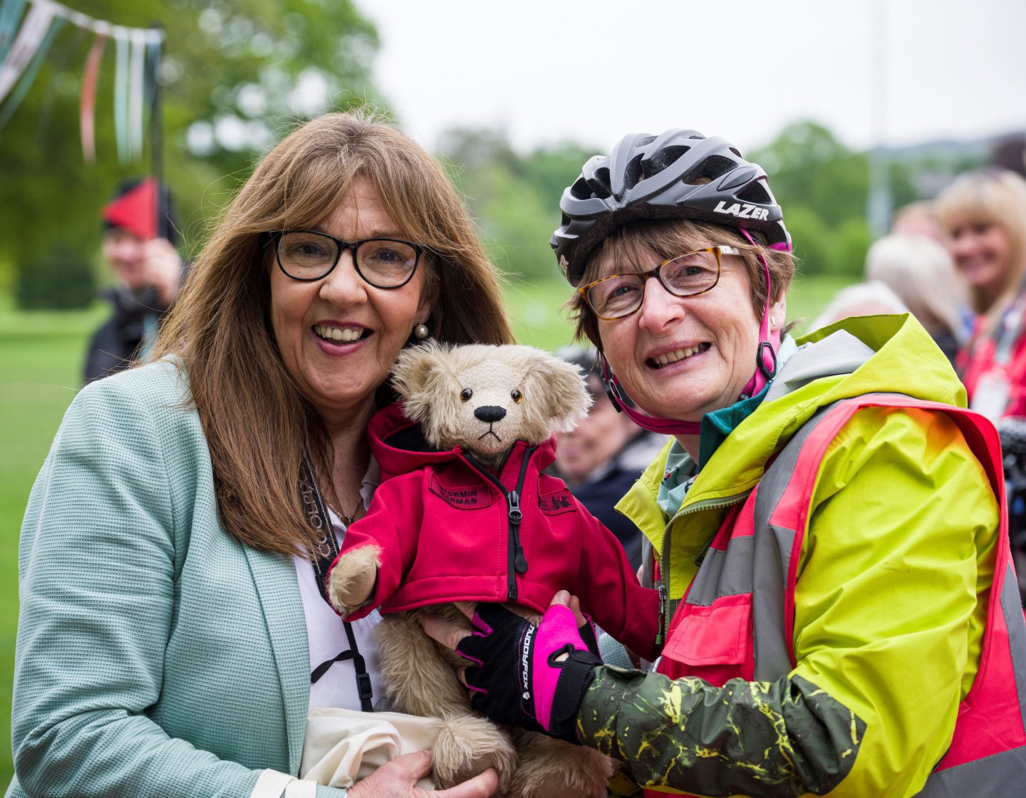 Christine Bell, chief executive of Cycling Without Age Scotland, with Norman Ridley's daughter Lorna and the Stormin' Norman bear.