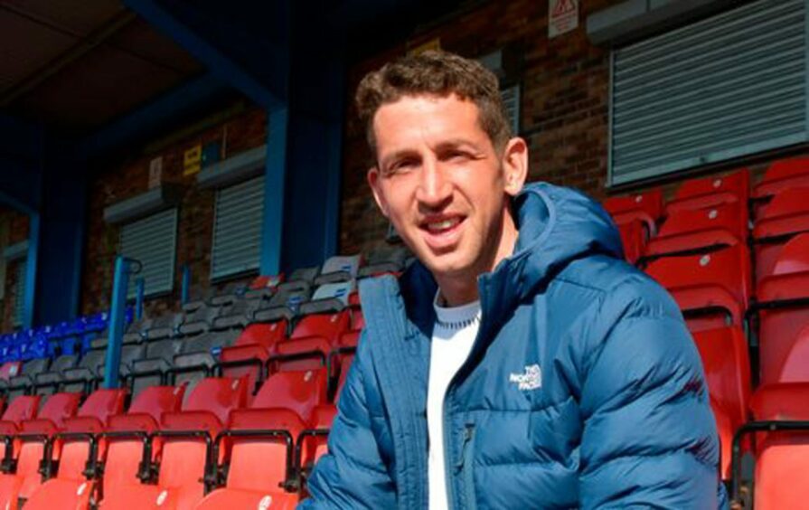 Calum Elliot sitting at Cowdenbeath FC.