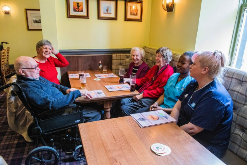 Residents, care workers and family socialising at the Kinloch Arms. Supplied: Chris Watt Photography.