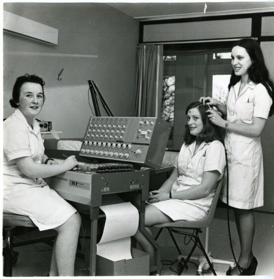 Student Nurses Sandra Brown, Joan Dickson and Elaine Shearer using an old-school EEG machine - used to measure brainwaves - at Ninewells Hospital, 1976. Image: DC Thomson.