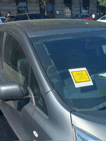 Dundee council leader John Alexander's car with a parking ticket on the windscreen