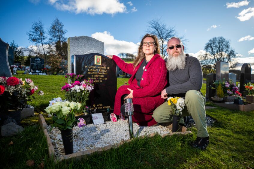 Louise Russell and David Christopher beside the grave of their son at Cupar Cemetery. Image: Kim Cessford/DC Thomson.