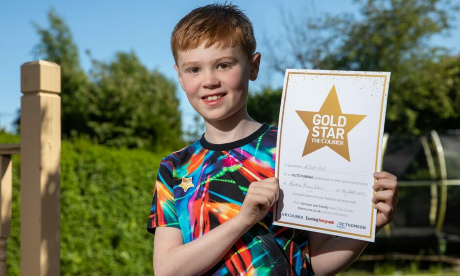 Elliot Hill with his Gold Star certificate