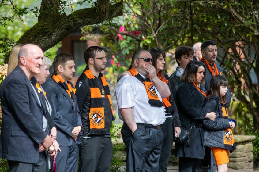 Mourners at Jack Stewart's funeral wearing Dundee United scarves
