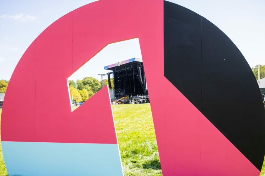 The Radio 1 3D logo with the Main stage in the background.