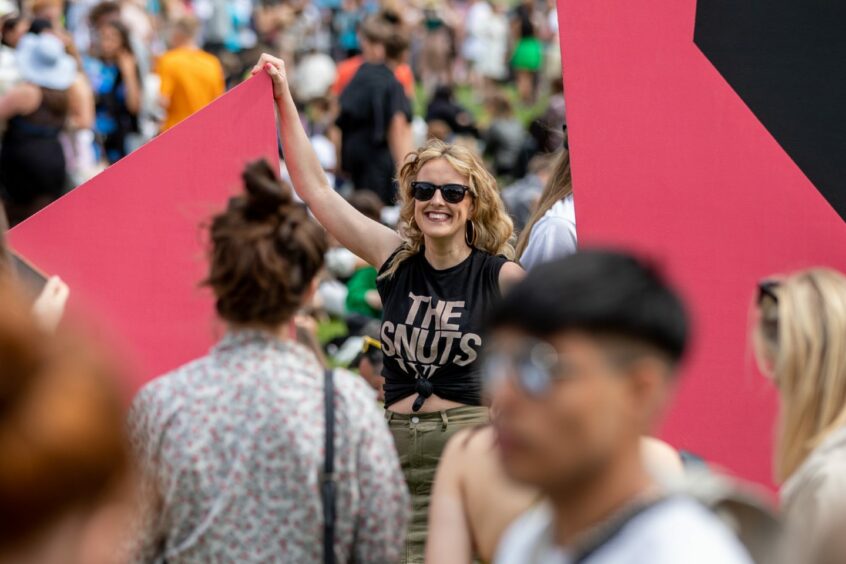 A fan of poses between the Radio 1 logo at Camperdown Park. Image: Kim Cessford / DC Thomson.