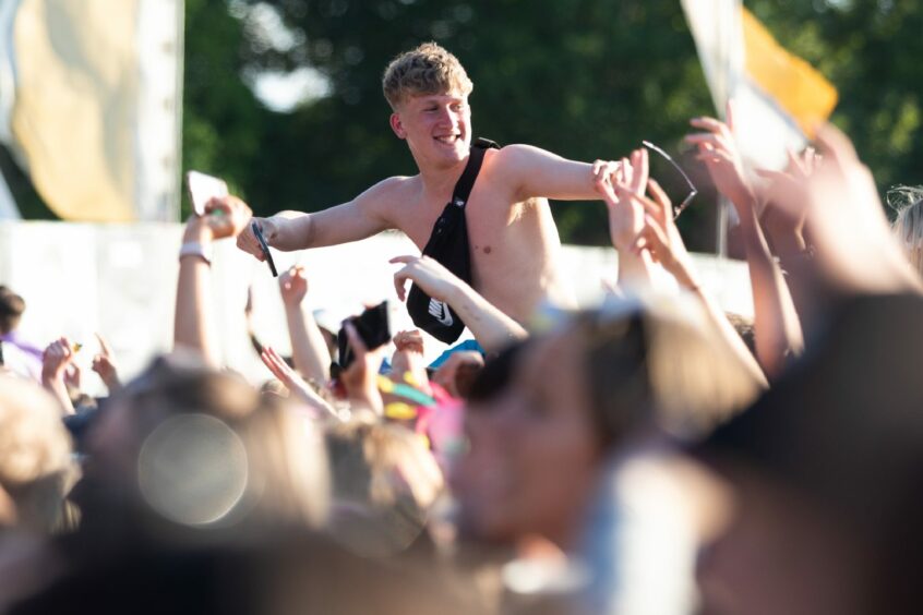 An audience member is lifted on to someone's shoulders to scout a better view of Tom Grennan's performance. Image: Kim Cessford / DC Thomson.