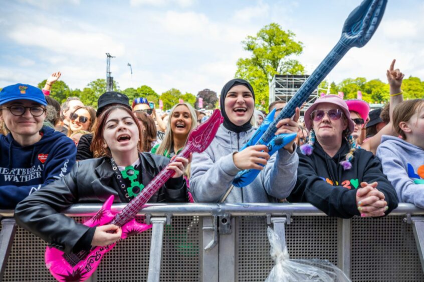Fans in the front row of the main stage at the Big Weekend.