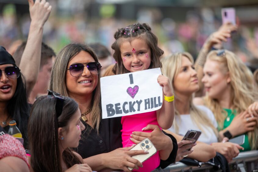 A girl with a sign saying "I love Becky Hill" at Radio 1's Big Weekend in Dundee