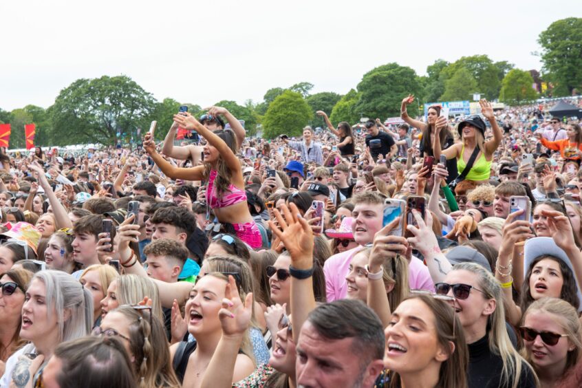 Fans look on as Becky Hill takes to the main stage.