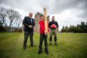 Strathmore Highland Games chairman Alan Wood and Brett Hampton of Valhalla Gym give young Marshall Cochrane a bit of encouragement with the caber. Image: Kim Cessford/DC Thomson