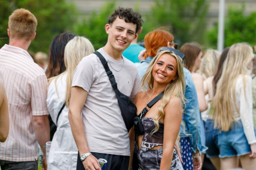 Pair smiling as they wait for transport to take them to the Big Weekend main stage on Saturday.