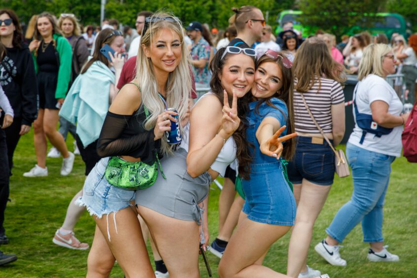 Group of friends posing for photos while they wait for the shuttle bus to Big Weekend.