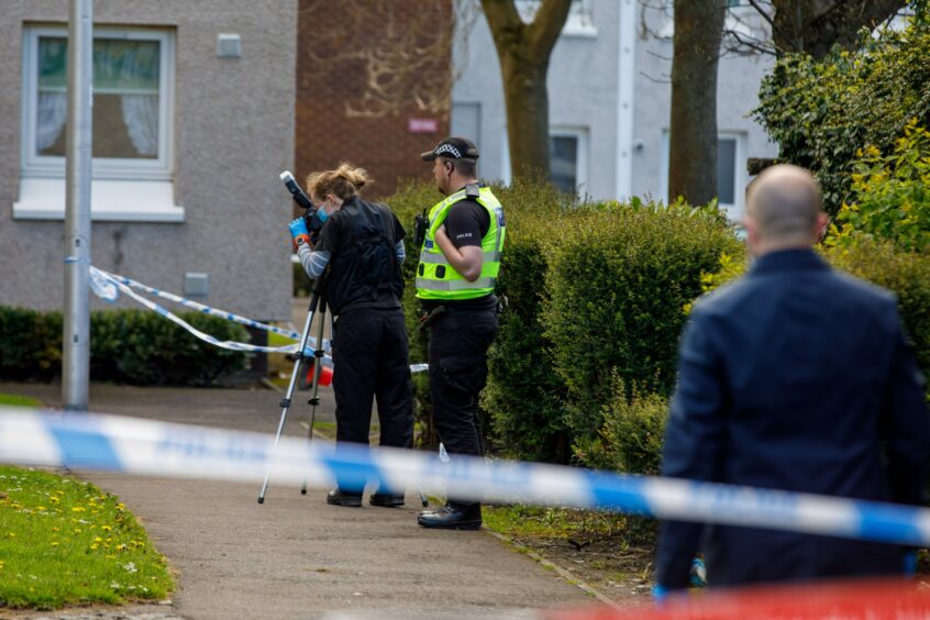 Forensics officers taking photos of the scene. Image: Kenny Smith/DC Thomson.