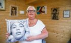 Gwen Denholm holding a cushion with Beyonce's face on it
