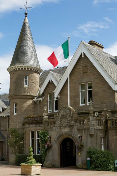 An Italian flag flying above the entrance of a Scottish house hotel.