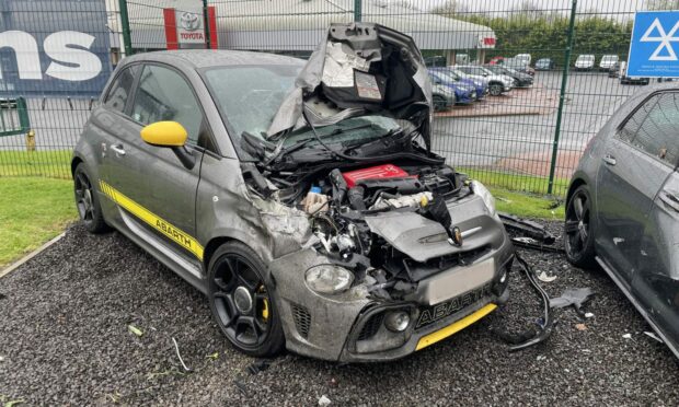 A badly damaged Fiat 500 Abarth still sits outside the dealership. Image: DC Thomson