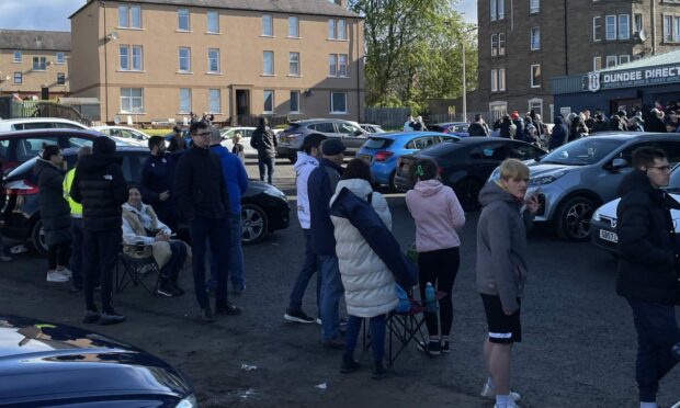 Dundee fans queue outside Dens Park to get tickets for the final day clash at Queen's Park.