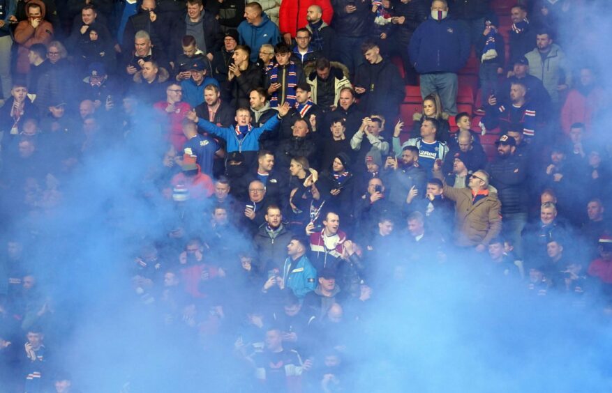 Rangers fans set off flares during the cinch Premiership match at McDiarmid Park, Perth.