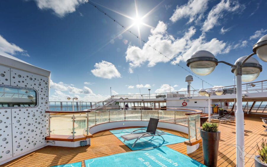 An outdoor swimming pool area on Artania cruise ship