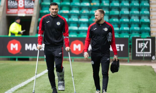 Watt, left, on crutches following his injury. Image: SNS