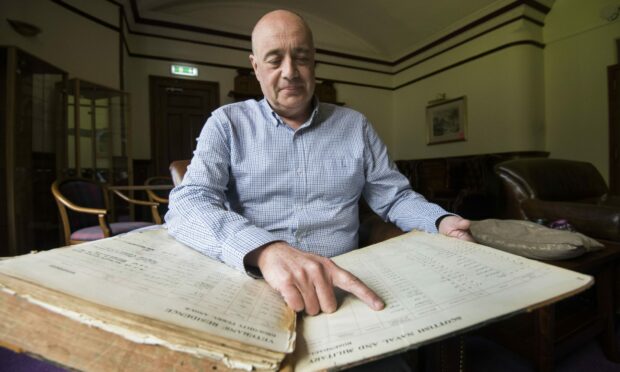 Manager of Rosendael in Broughty Ferry, Graeme Watson with the residents ledger dating back to the home's opening in 1933.