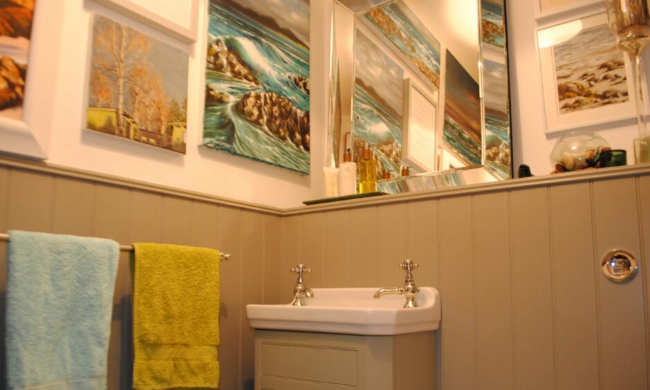 Laura's artworks hang in the 'Loovre' in Daisy Cottage. Image: BBC Scotland.