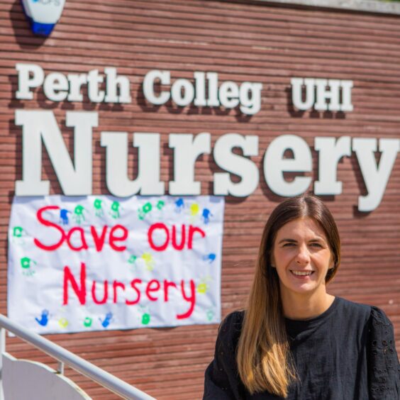 Nursery manager Lianne Schemper outside the nursery with a "save out nursery sign" in the background.