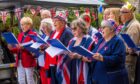 Comrie Parish Singers at the village's street party to mark the coronation of King Charles III. Image: Steve MacDougall/DC Thomson.