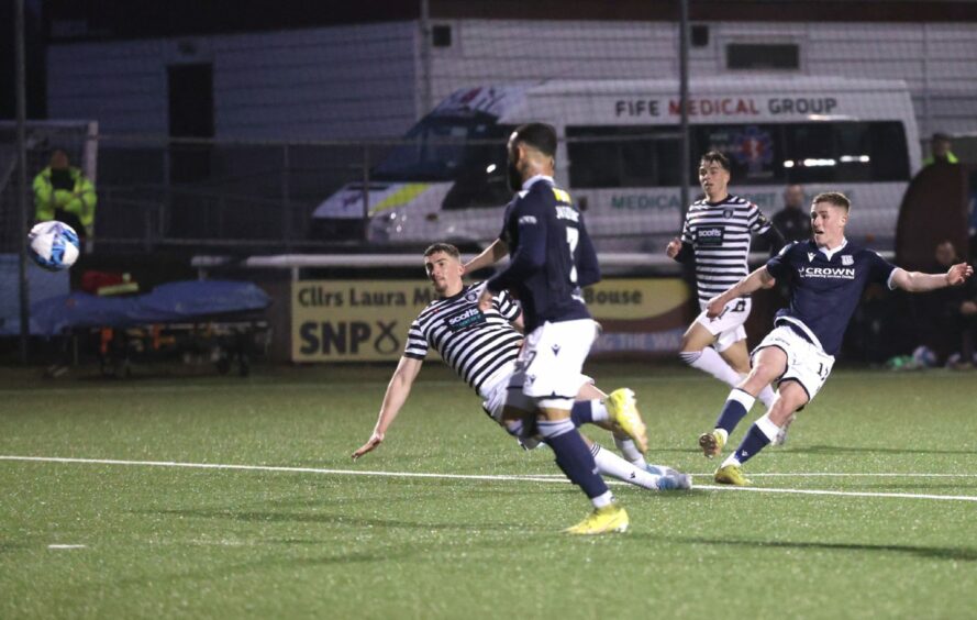 Luke McCowan curls in fifth goal of the game for Dundee to clinch Championship title.