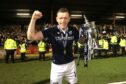 Dundee's Lee Ashcroft celebrates with the Championship trophy. Image: PA.