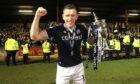 Dundee's Lee Ashcroft celebrates with the Championship trophy. Image: PA.