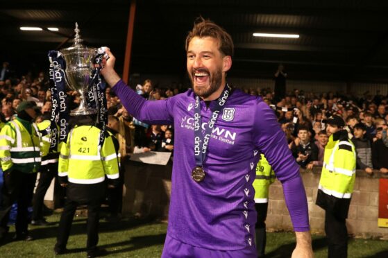 Dundee goalkeeper Adam Legzdins celebrates winning the Championship at Ochilview. Image: PA