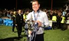 Former Dundee manager Gary Bowyer celebrates with the Championship trophy. Image: PA.