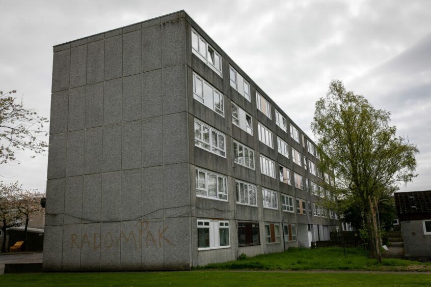 Another view of Abbotsford Court flats in Glenrothes including graffiti on the wall